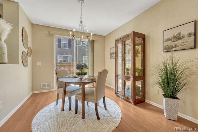 17225 Lark Water Ln Unit C, Parker, CO 80134 - dining space featuring wood finished floors and a chandelier