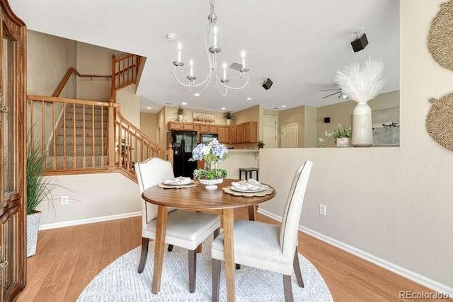 17225 Lark Water Ln Unit C, Parker, CO 80134 - dining area featuring light wood-style floors, stairway, a chandelier, and recessed lighting