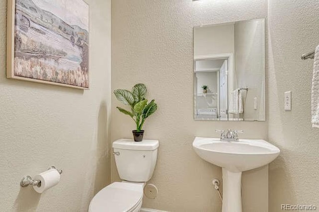 17225 Lark Water Ln Unit C, Parker, CO 80134 - bathroom featuring toilet and a textured wall