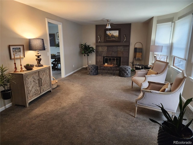 living room featuring a tiled fireplace, carpet flooring, and baseboards