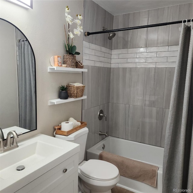 bathroom featuring toilet, shower / bathtub combination with curtain, and vanity