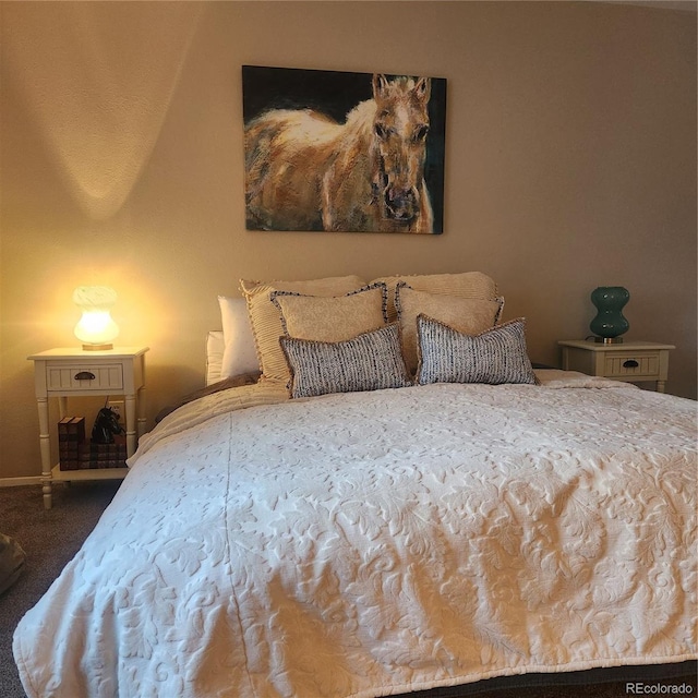 carpeted bedroom featuring baseboards