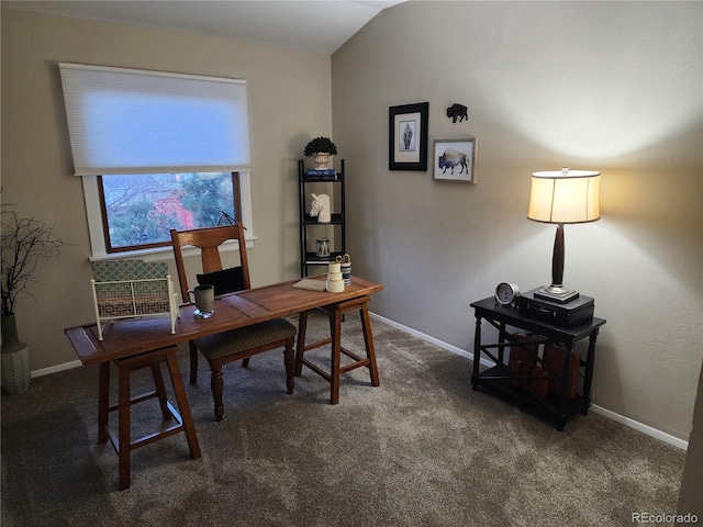 office featuring dark carpet, vaulted ceiling, and baseboards