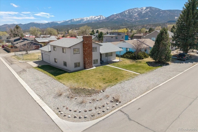 birds eye view of property with a residential view and a mountain view