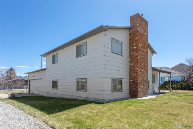 view of side of home featuring a lawn and a chimney