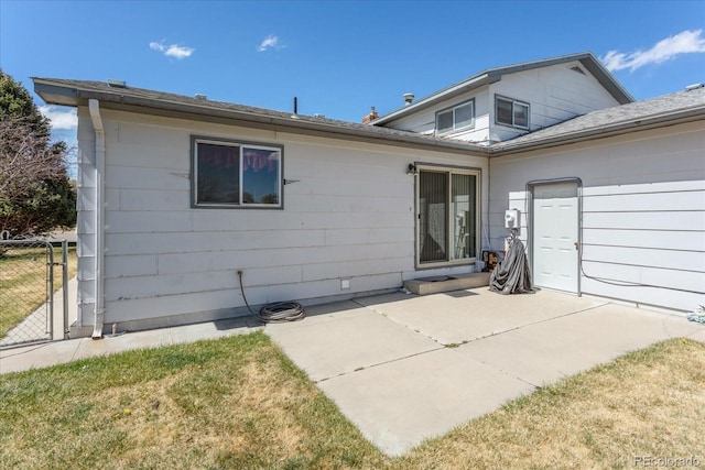 back of property featuring a patio area and fence