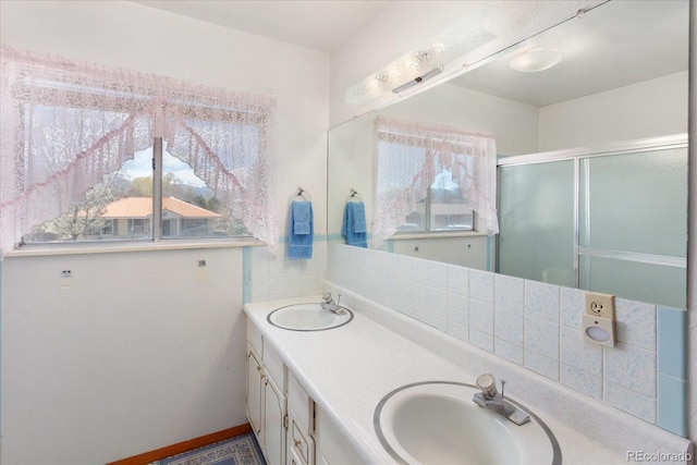 bathroom with plenty of natural light, a sink, and double vanity