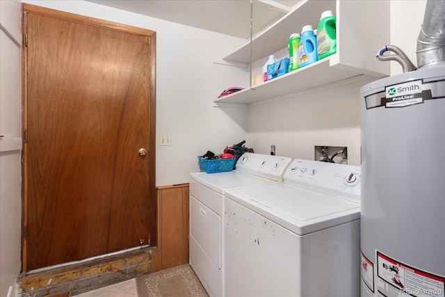 clothes washing area featuring washer and dryer, laundry area, and water heater
