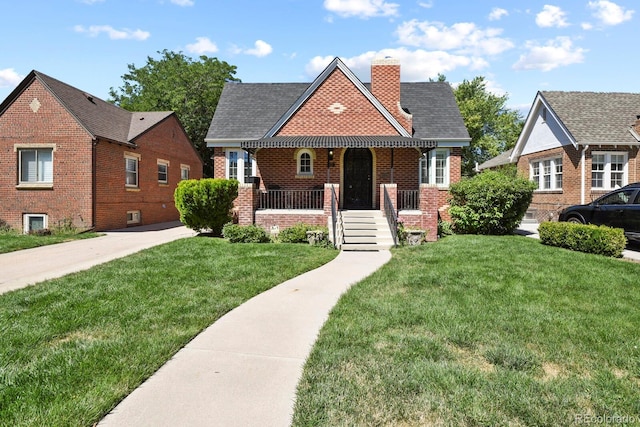 view of front of house with a front yard and covered porch