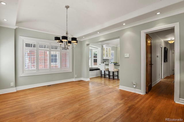 unfurnished dining area with an inviting chandelier, hardwood / wood-style floors, and lofted ceiling