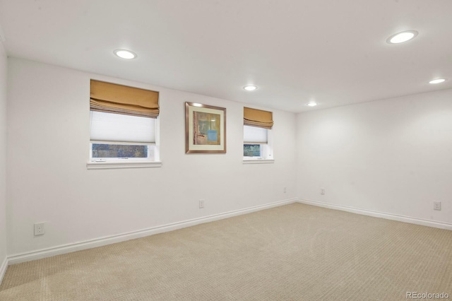 spare room featuring light colored carpet and a healthy amount of sunlight