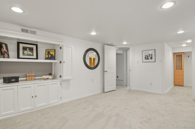 unfurnished living room with light colored carpet