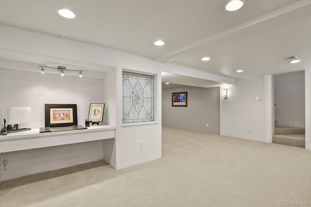 interior space with light colored carpet and built in desk