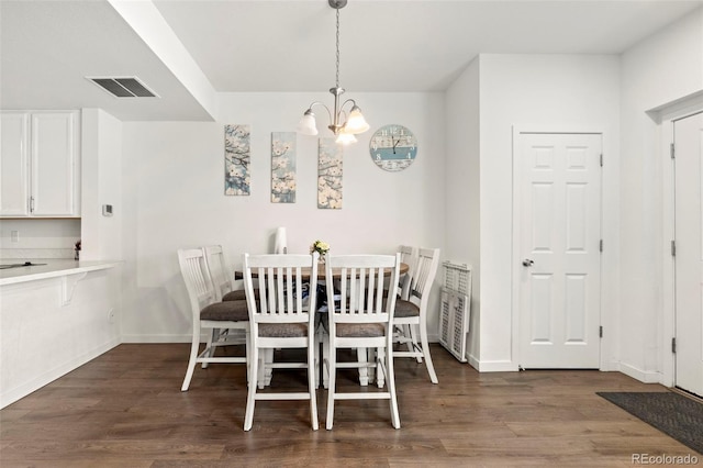 5744 Alton St, Denver, CO 80238 - dining space with a chandelier, wood finished floors, and baseboards