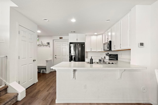 5744 Alton St, Denver, CO 80238 - kitchen with refrigerator with ice dispenser, range, a peninsula, a kitchen bar, and light countertops