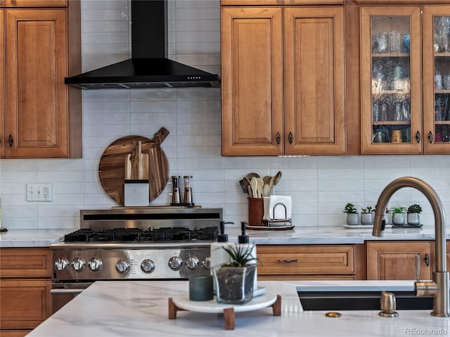 kitchen with wall chimney exhaust hood and brown cabinets