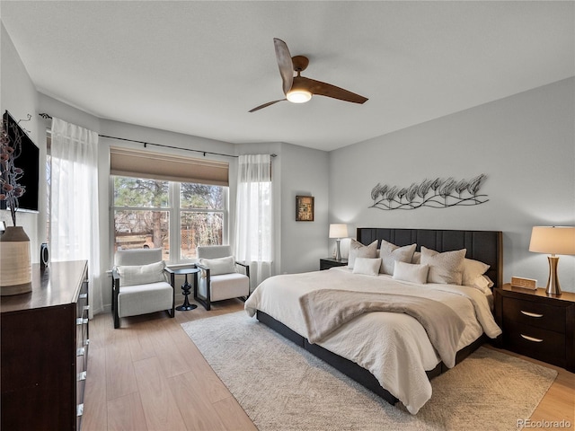 bedroom with a ceiling fan and light wood-style floors