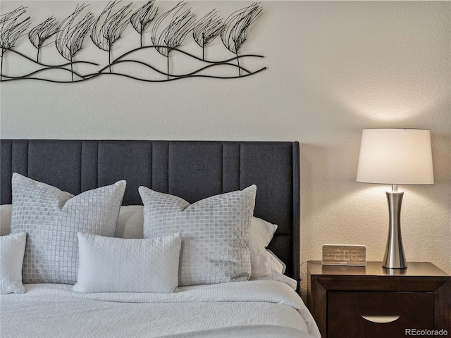 bedroom featuring a textured wall