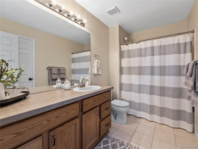 bathroom featuring visible vents, vanity, toilet, and tile patterned floors