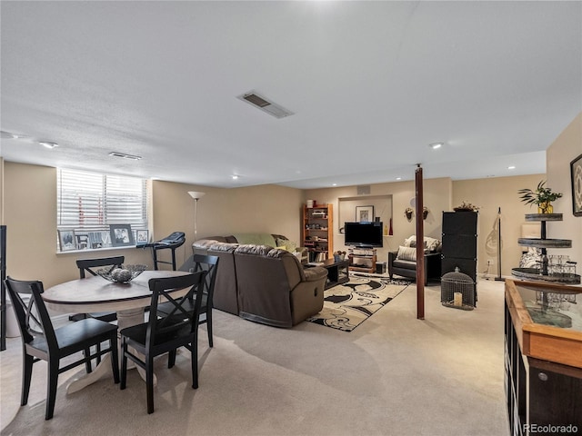 living area featuring light colored carpet, visible vents, and recessed lighting