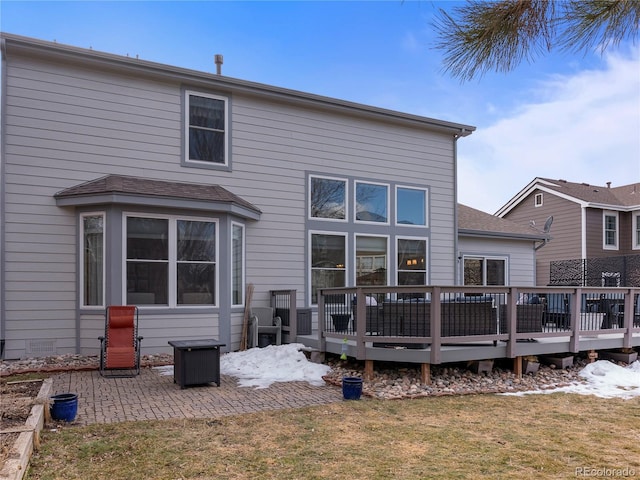 back of property with a patio area, a lawn, and a wooden deck