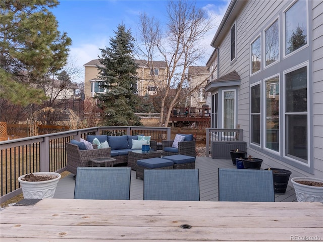 deck with outdoor dining space and an outdoor living space