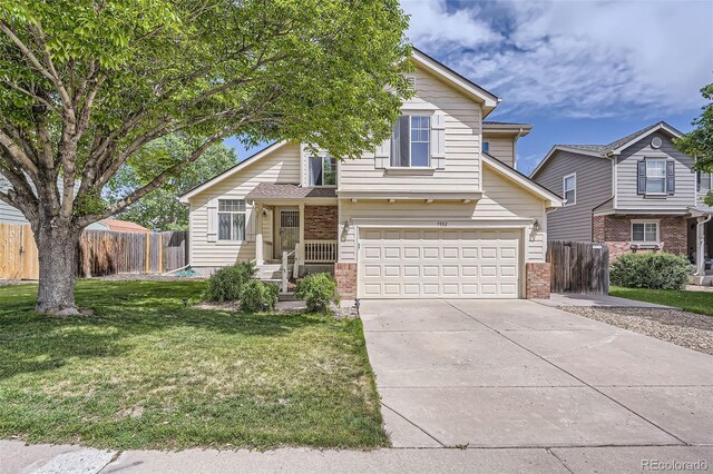 9882 Harris St, Thornton, CO 80229 - view of front of property featuring brick siding, a garage, and concrete driveway