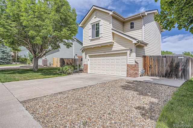 9882 Harris St, Thornton, CO 80229 - view of front of home with a garage, brick siding, and driveway