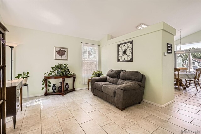 9882 Harris St, Thornton, CO 80229 - living room featuring lofted ceiling and light tile patterned floors