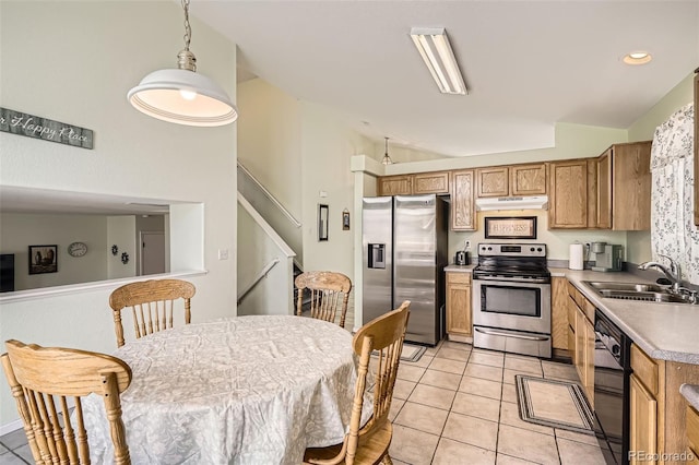 9882 Harris St, Thornton, CO 80229 - kitchen featuring appliances with stainless steel finishes, vaulted ceiling, under cabinet range hood, light tile patterned floors, and light countertops