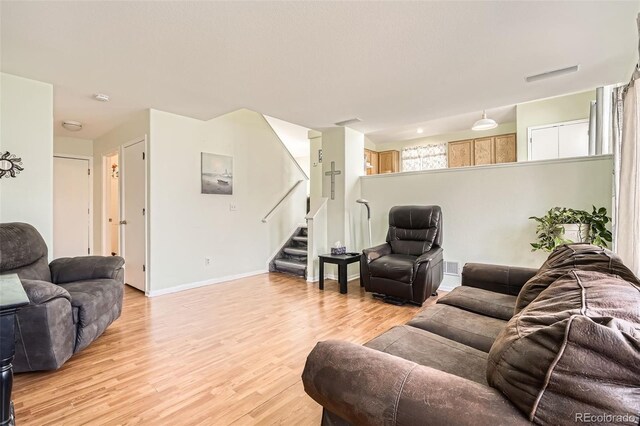 9882 Harris St, Thornton, CO 80229 - living area featuring light wood-type flooring and stairway