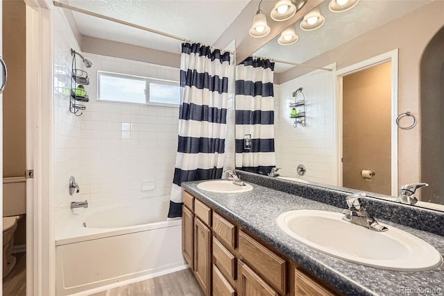 9882 Harris St, Thornton, CO 80229 - bathroom with shower / bath combination with curtain, double vanity, and wood finished floors
