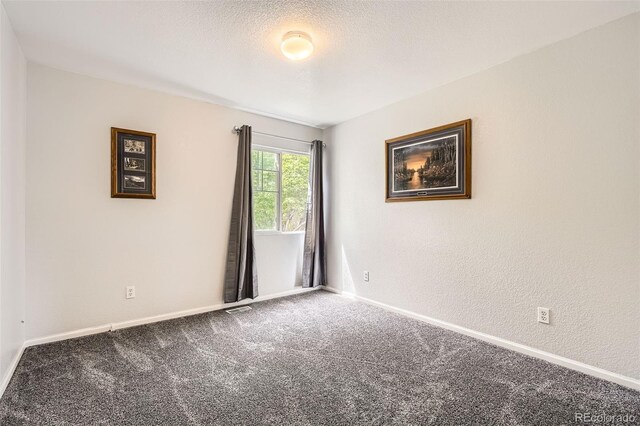 9882 Harris St, Thornton, CO 80229 - carpeted empty room with baseboards and a textured ceiling