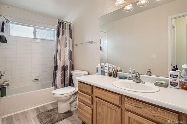 9882 Harris St, Thornton, CO 80229 - bathroom with vanity, shower / tub combo, and wood finished floors