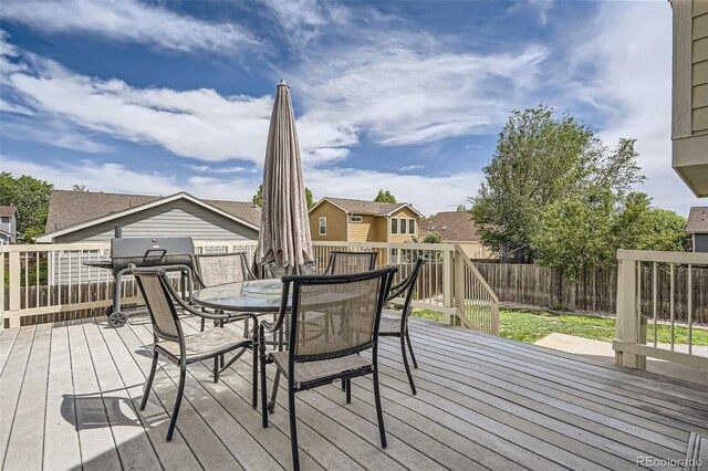 9882 Harris St, Thornton, CO 80229 - wooden terrace featuring a fenced backyard and outdoor dining area