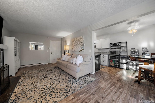 living room with ceiling fan, dark hardwood / wood-style floors, a textured ceiling, and a baseboard heating unit