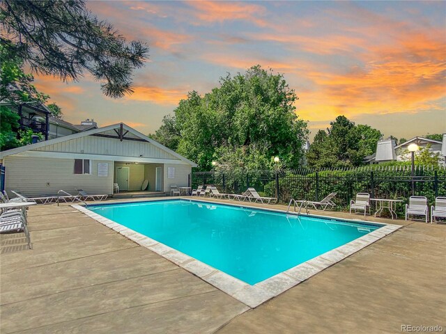 pool at dusk with a patio