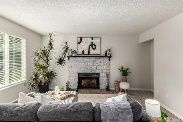 4784 S Tabor St, Morrison, CO 80465 - living room with a stone fireplace, a textured ceiling, plenty of natural light, and carpet floors
