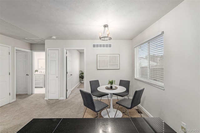 4784 S Tabor St, Morrison, CO 80465 - dining space featuring carpet flooring and a chandelier