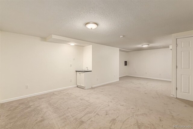 4784 S Tabor St, Morrison, CO 80465 - finished below grade area featuring a textured ceiling and light colored carpet