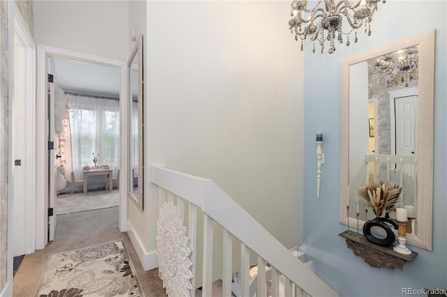 9620 W Chatfield Ave Unit D, Littleton, CO 80128 - hall with a chandelier, an upstairs landing, and carpet flooring