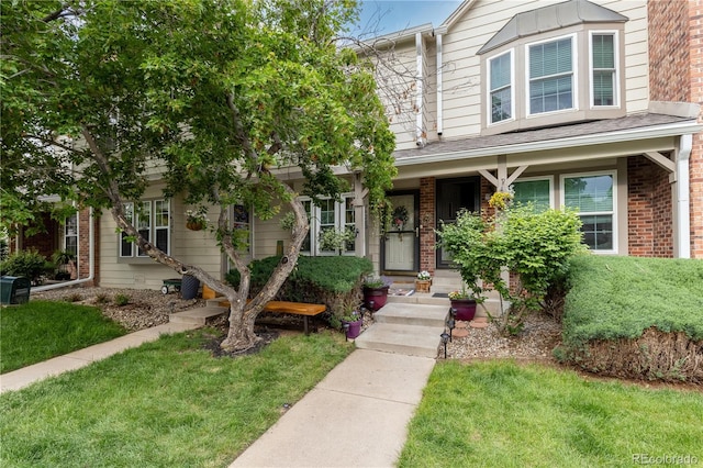 9620 W Chatfield Ave Unit D, Littleton, CO 80128 - view of front of property featuring a front lawn and brick siding