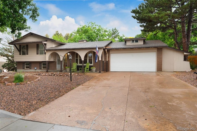5214 Alta Loma Rd, Colorado Springs, CO 80918 - split level home with covered porch, brick siding, a garage, and driveway