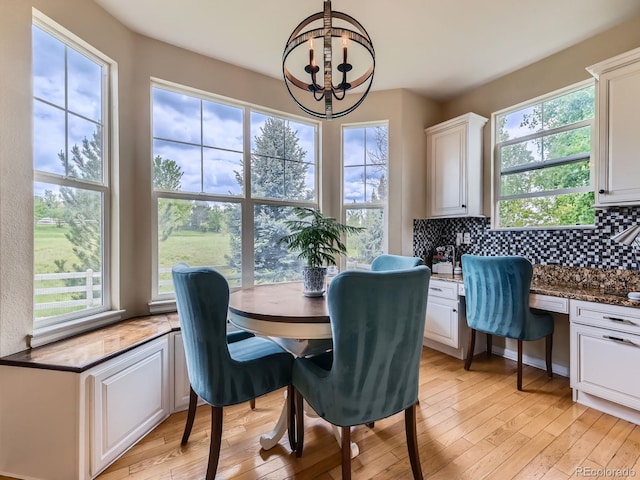 2896 Gemini Loop, Broomfield, CO 80023 - dining area with a chandelier and light wood-style floors