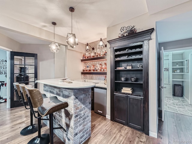 2896 Gemini Loop, Broomfield, CO 80023 - indoor wet bar featuring refrigerator, light wood finished floors, and hanging light fixtures