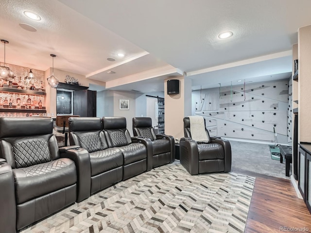 2896 Gemini Loop, Broomfield, CO 80023 - home theater room with a barn door, light wood-style floors, bar, a textured ceiling, and recessed lighting