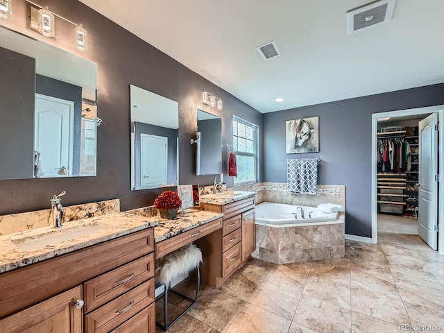 2896 Gemini Loop, Broomfield, CO 80023 - bathroom featuring a garden tub, vanity, and a spacious closet