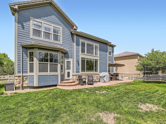 2896 Gemini Loop, Broomfield, CO 80023 - rear view of property with stone siding, a patio, and entry steps