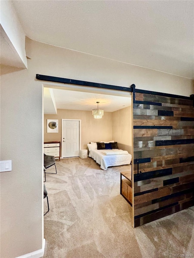 2896 Gemini Loop, Broomfield, CO 80023 - bedroom featuring a barn door and carpet flooring