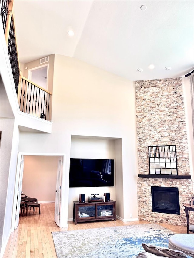 2896 Gemini Loop, Broomfield, CO 80023 - living room with hardwood / wood-style flooring, a stone fireplace, and recessed lighting